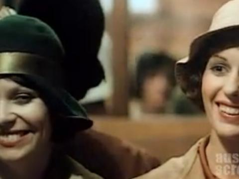 Film still of Jacki Weaver as Josie and Helken Morse as Caddie laughing on a tram.