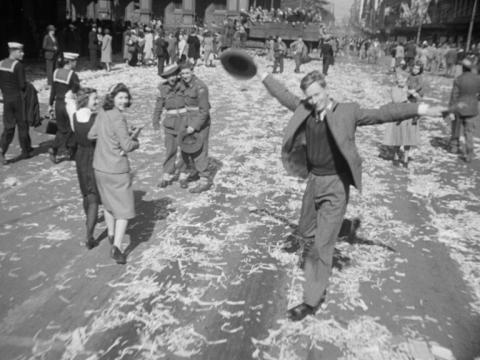 A man dances in the street to celebrate the end of the Second World War