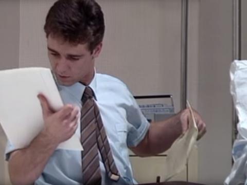 A young Russell Crowe looking at paperwork, as part of a role playing exercise, in the short film Manager on the Case