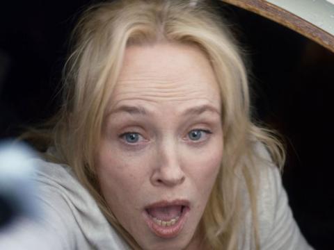Close up of a terrified woman.