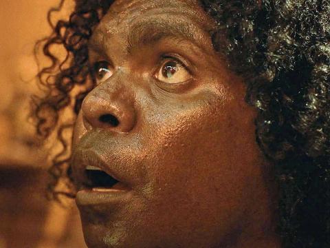 Big close up of a young Aborigina boy looking up.
