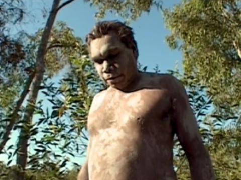 Bare chested and painted Aboriginal man
