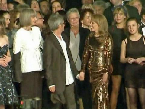 Kylie Minogue with cast and Director from the film Holy Motors at the Cannes Film Festival. Kylie is wearing a shimmering, gold floor length gown.