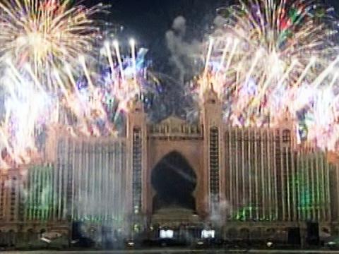 The front of the Atlantis Hotel in 2008 lit up at night time, with fireworks exploding in the background.