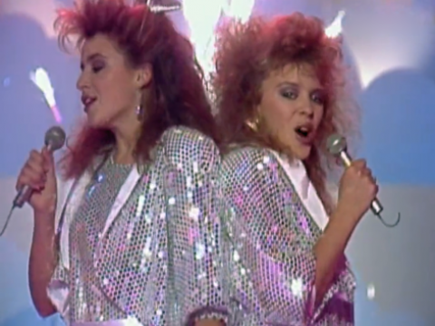 Kylie and Dannii Minogue on stage singing in a TV studio in 1986.