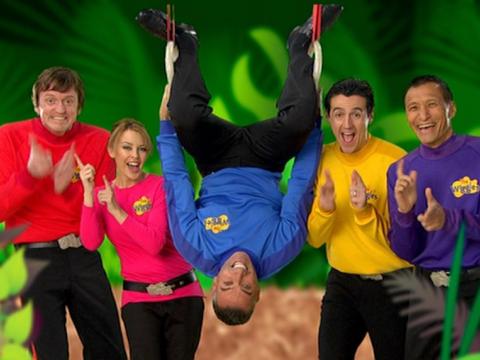 Kylie Minogue joins The Wiggles doing their famous finger dance with a jungle background. Anthony Field is hanging upside-down.