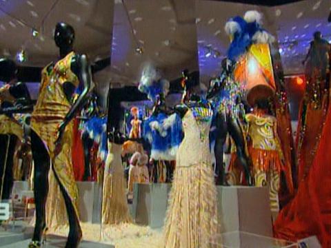 An exhibition space filled with mannequins wearing colourful, glittery costumes once worn by Kylie Minogue
