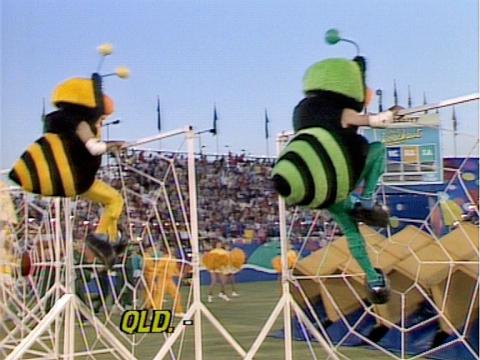 Two people dressed in bee costumes tackle an obstacle course in a fun game show.
