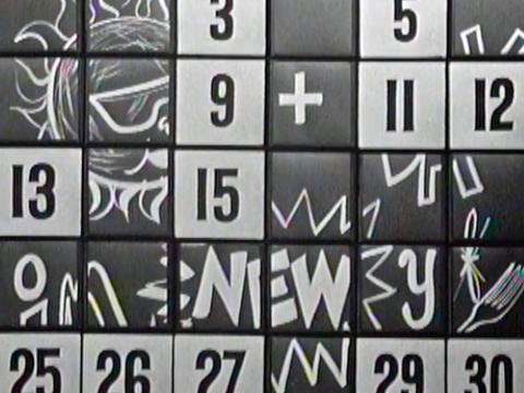 A board with numbers and picture clues on it from a game show.