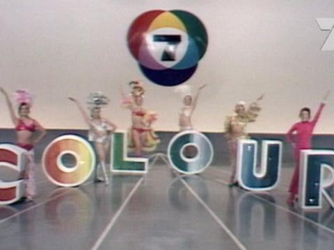 A colourful studio set featuring dancers around the words 'colour'