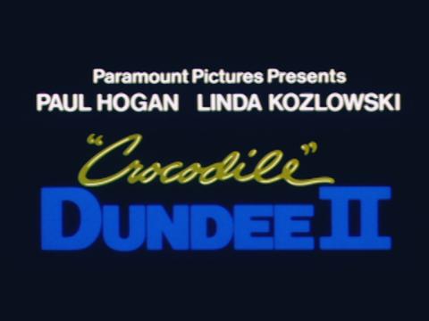Title card from the Crocodile Dundee II trailer. It says 'Paramount Pictures Presents Paul Hogan, Linda Kozlowski. Crocodile Dundee II.