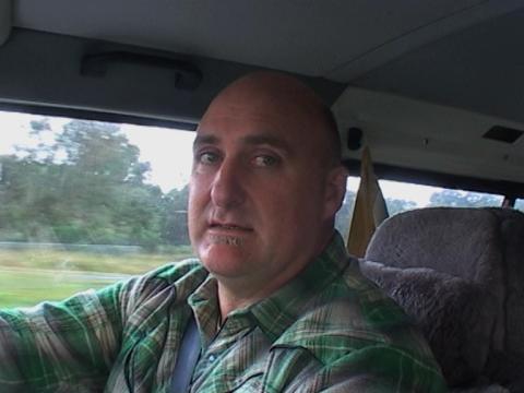 Filmmaker David Caesar gives an interview from the driver's seat of his car