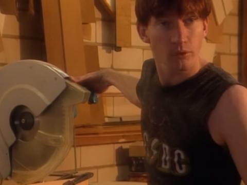 David Wenham, wearing a singlet, working in a kitchen manufacturing workshop
