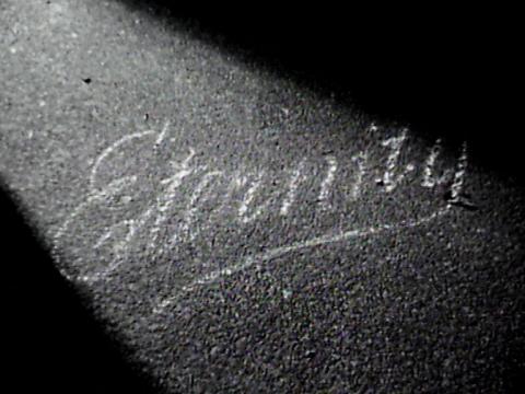 The word 'Eternity' is written in chalk in copperplate handwriting on a pavement. 