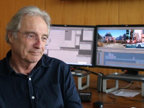 Filmmaker Ray Lawrence sits in an office