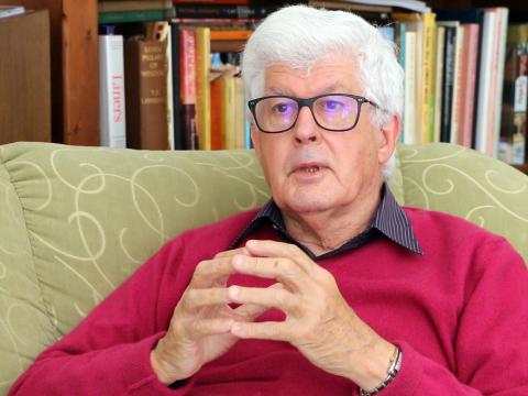 Filmmaker Anthony Buckley sits in his home