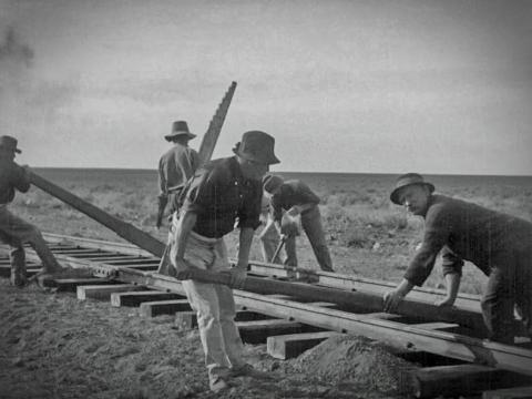 Railway workers on the Nullarbor laying rail lines and sleepers, circa 1917.