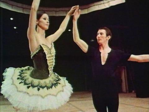 Two ballet dancers Marilyn Rowe and Kelvin Coe strike a pose together in costume.