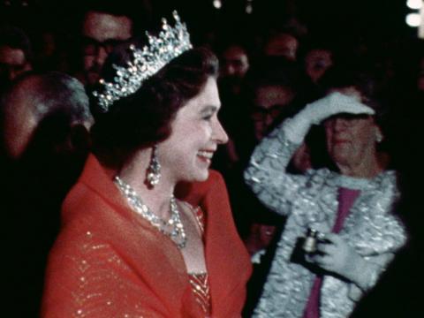 Queen Elizabeth II is seen in side profile. She is wearing jewels and a crown.