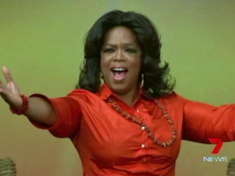 American talk show queen Oprah Winfrey has her arms outstretched in gesture of welcome.
