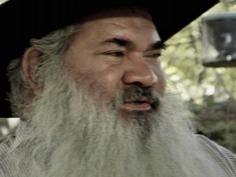 Close up of Australian senator Pat Dodson wearing a black hat.