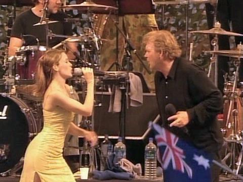 Kylie Minogue and John Farnham singing on stage together in East Timor