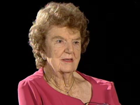 A woman is being interviewed in a studio setting.