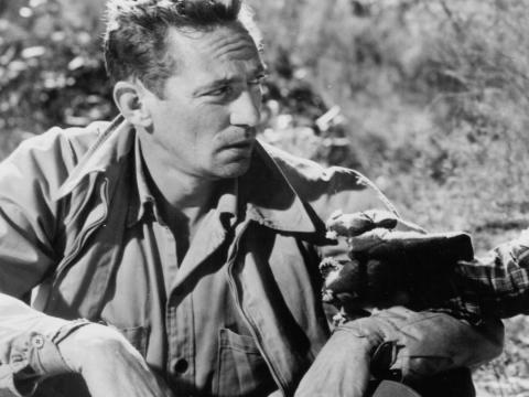 Peter Finch seated outdoors in The Shiralee