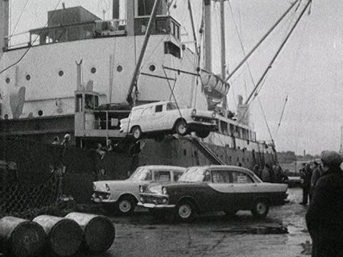 Holden cars are loaded off a ship at a port