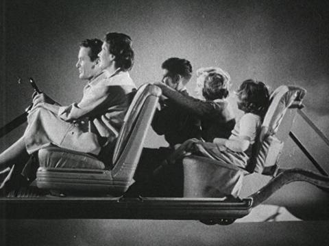 A family of six sits inside a Holden car