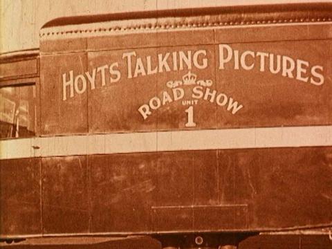 The side of a Hoyts truck touring talking pictures in 1929 and labelled 'Hoyts Talking Pictures Roadshow'