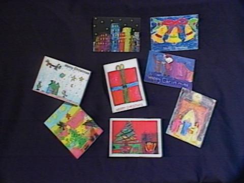 Eight different Christmas card designs drawn by children.