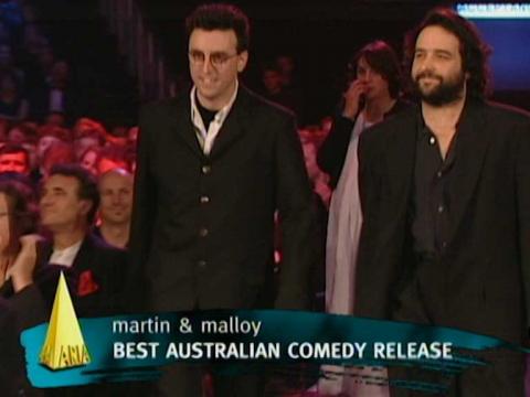 Tony Martin and Mick Molloy walking to accept the award for Best Australian Comedy Release at the 1996 ARIA Awards