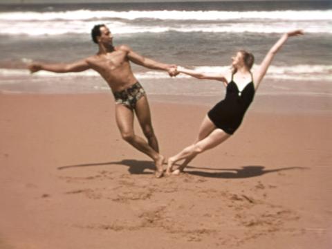 Screenshot of Ballet Russes dancers on Bungan Beach holding a dance pose.
