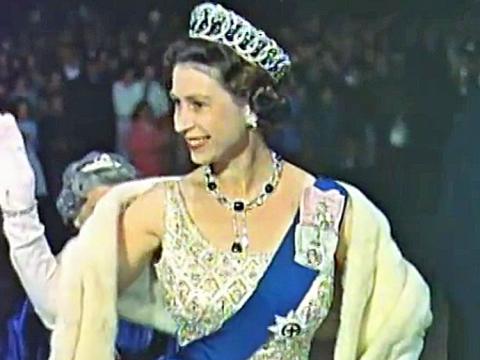 The Queen arriving at a ceremony in Canberra, waving to onlookers in 1963.