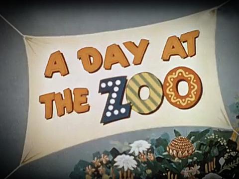 Brightly coloured banner with the words 'A Day at the Zoo' written on it. Below the banner is a cluster of flowers.