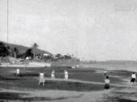 A grainy black and white still image from a 1933 home movie of some women playing cricket on Thursday Island in the Torres Strait.