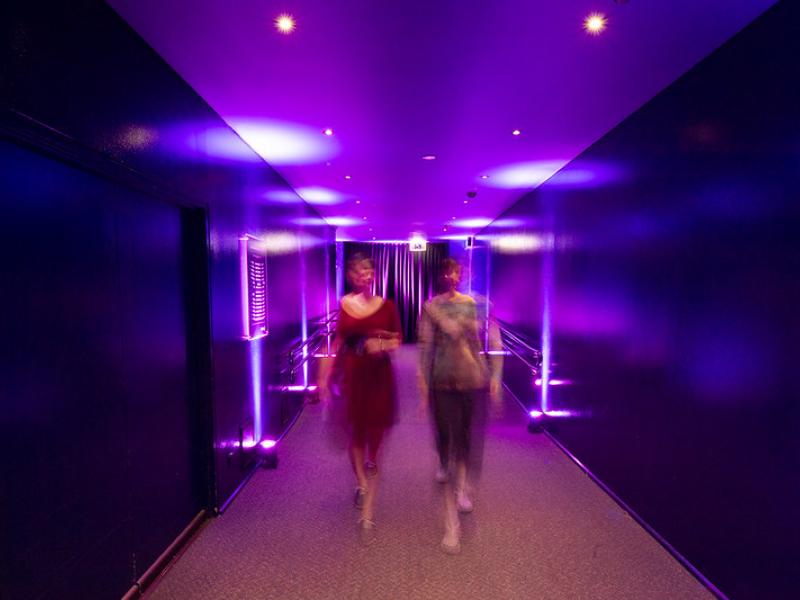 Two people walking into entrance of cinema