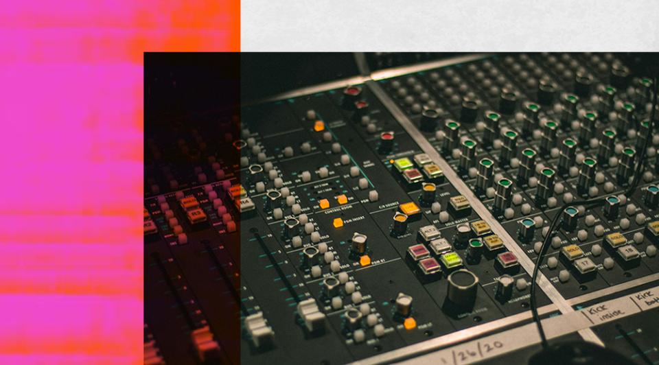 A studio mixing desk covered in buttons and switches