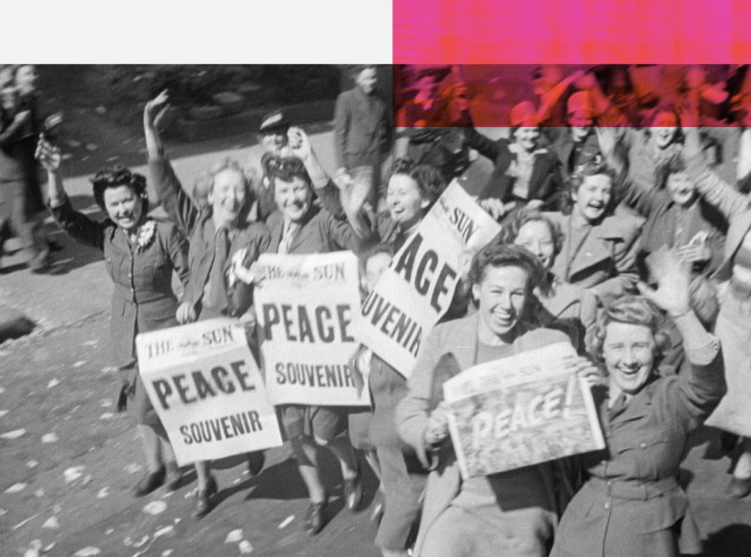 Women holding Peace signs and celebrating in the street at the end of the second world war.