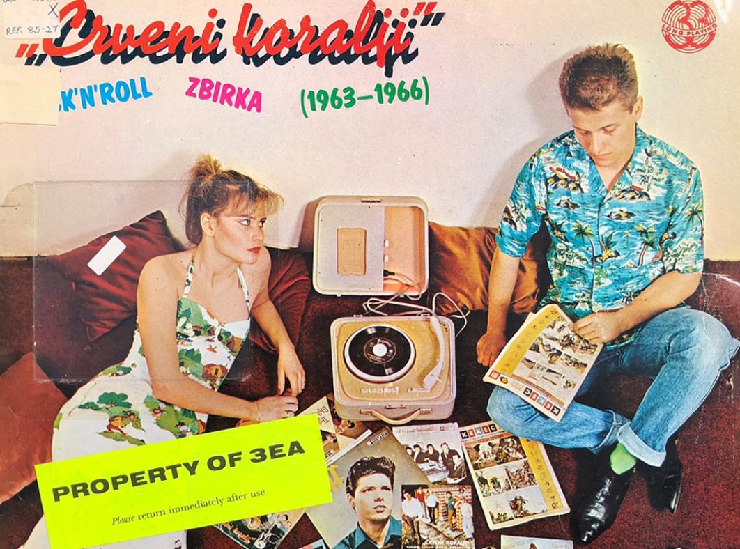 Detail from an album cover showing a man and women sitting in the floor with a pile of records and a portable record player