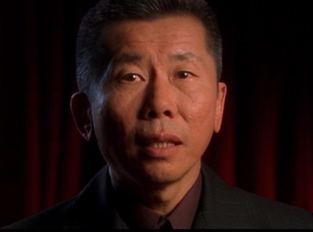 William Yang looking direct to camera in a scene from the documentary Sadness