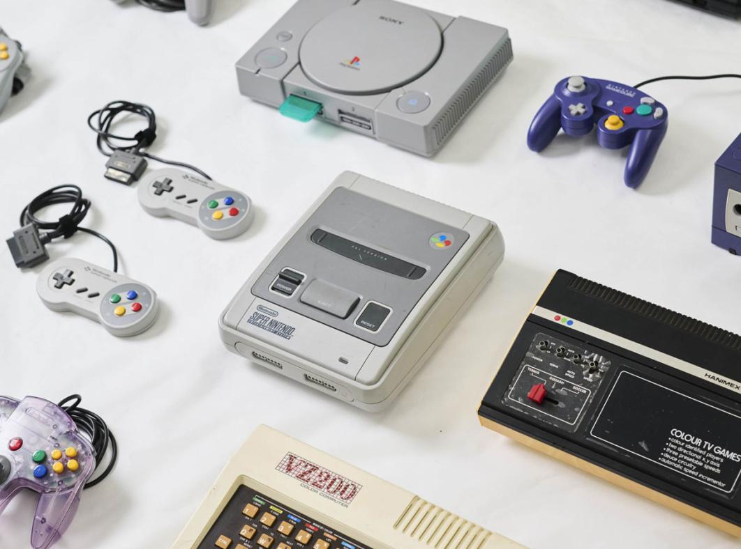 Video game consoles and hardware laid out on a table
