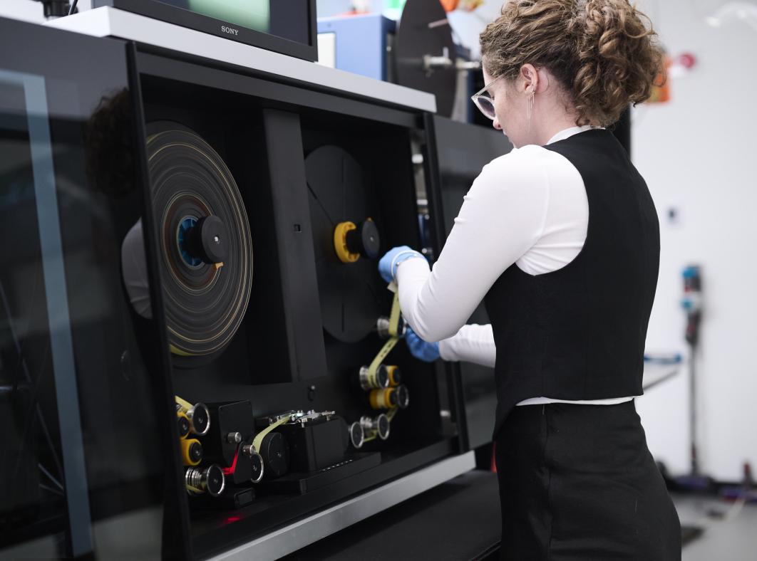 Woman working at a film digitisation machine