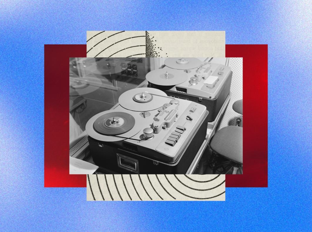 Two reel-to-reel tape recorders sitting next to each other in a recording studio