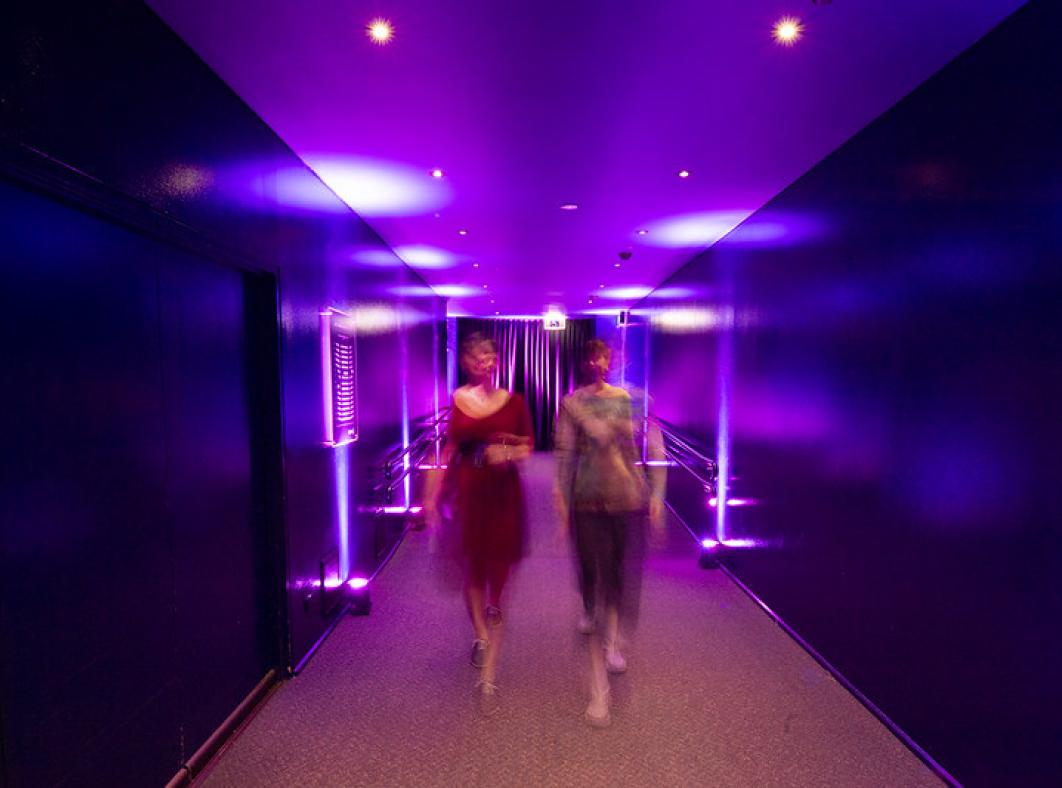 Two people walking into entrance of cinema