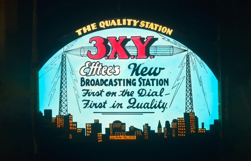 glass cinema side featuring an advertisement for radio station 3XY