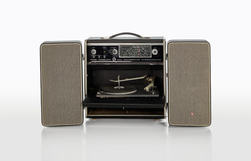 Portable radio received with fold out speakers on the side and a carry handle on top