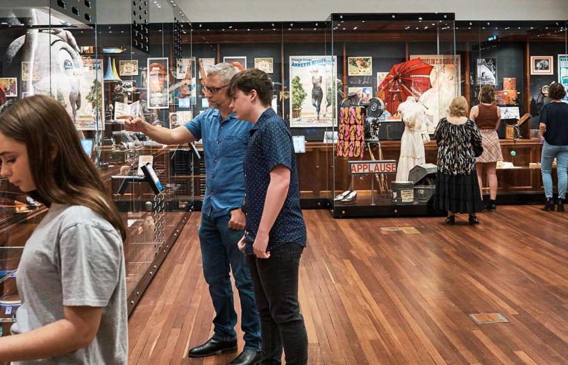 People looking at items in an exhibition space.