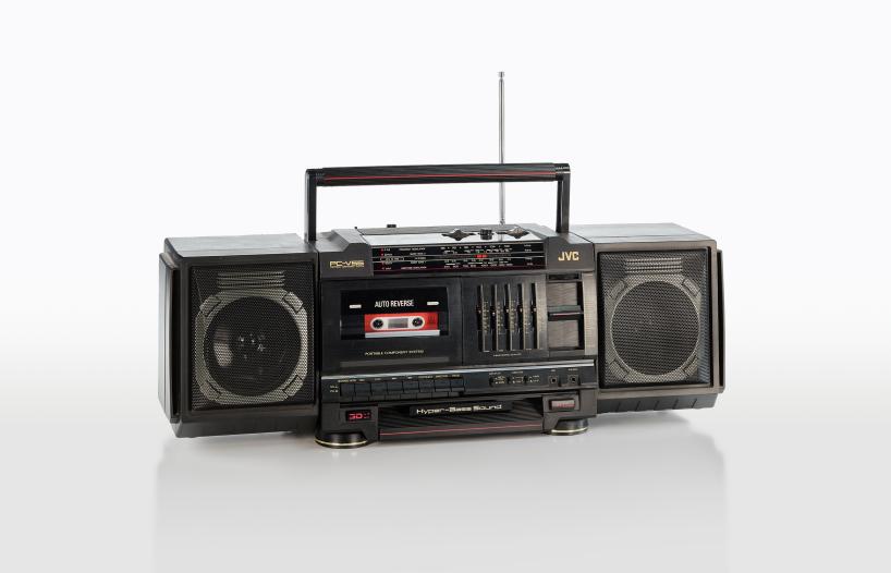 A rectangular black portable radio and cassette recorder from the 1980s with speakers on either end and a tape deck in the middle.